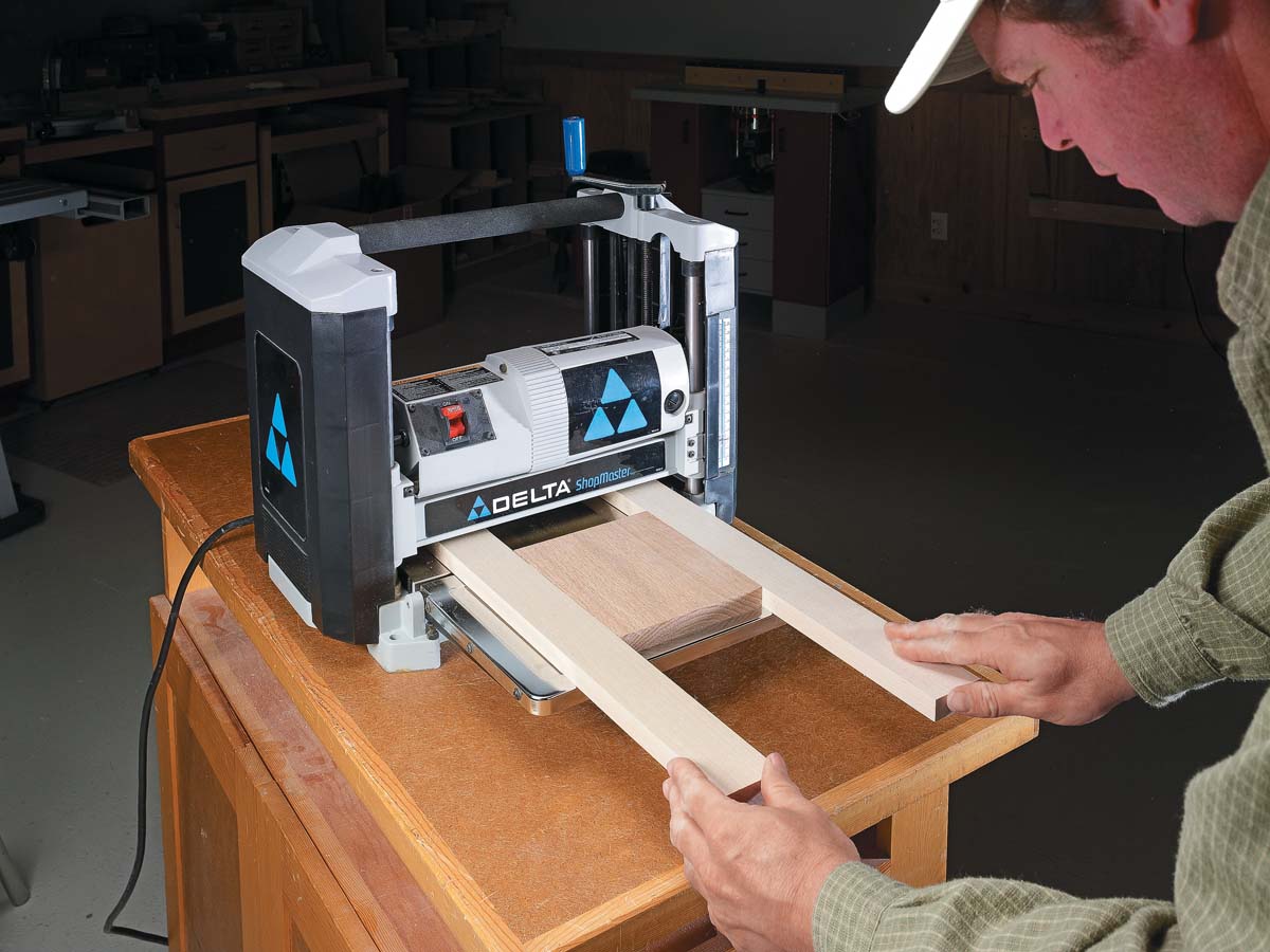 pushing wood into planer
