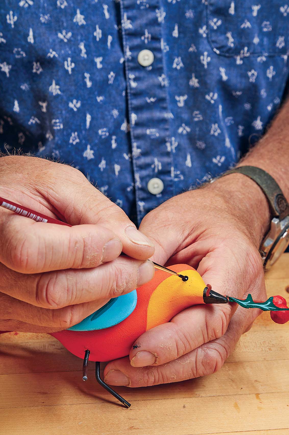 Painting bird eye with round brush and black paint