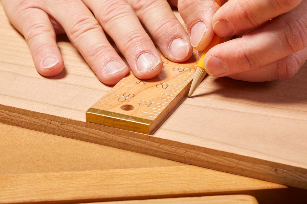 using wood ruler to make pencil markings