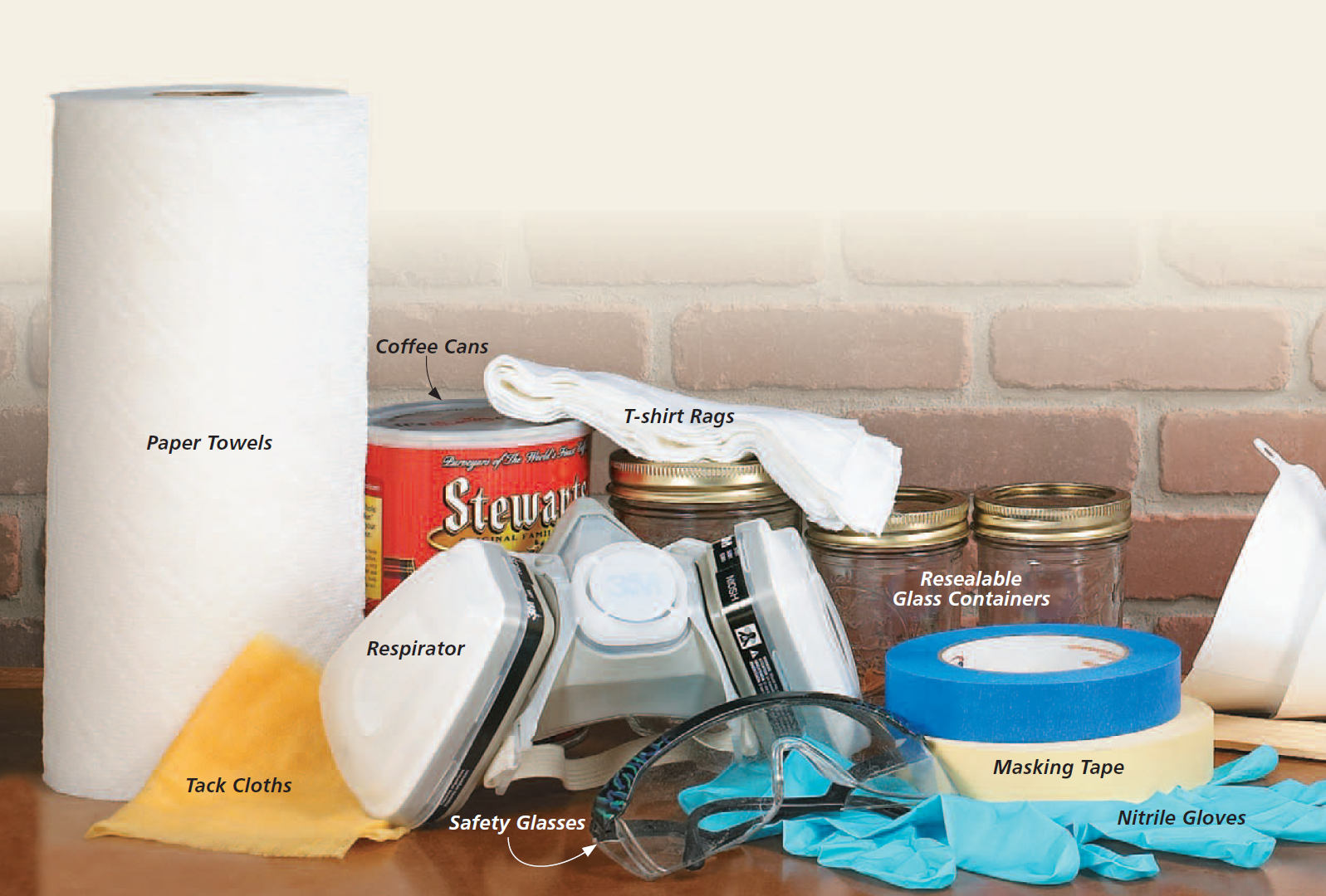 image of supplies for finishing includes paper towels, rags, coffee cans, mason jars, tack clothes, respirator, safety glasses, masking tape, nitrile gloves