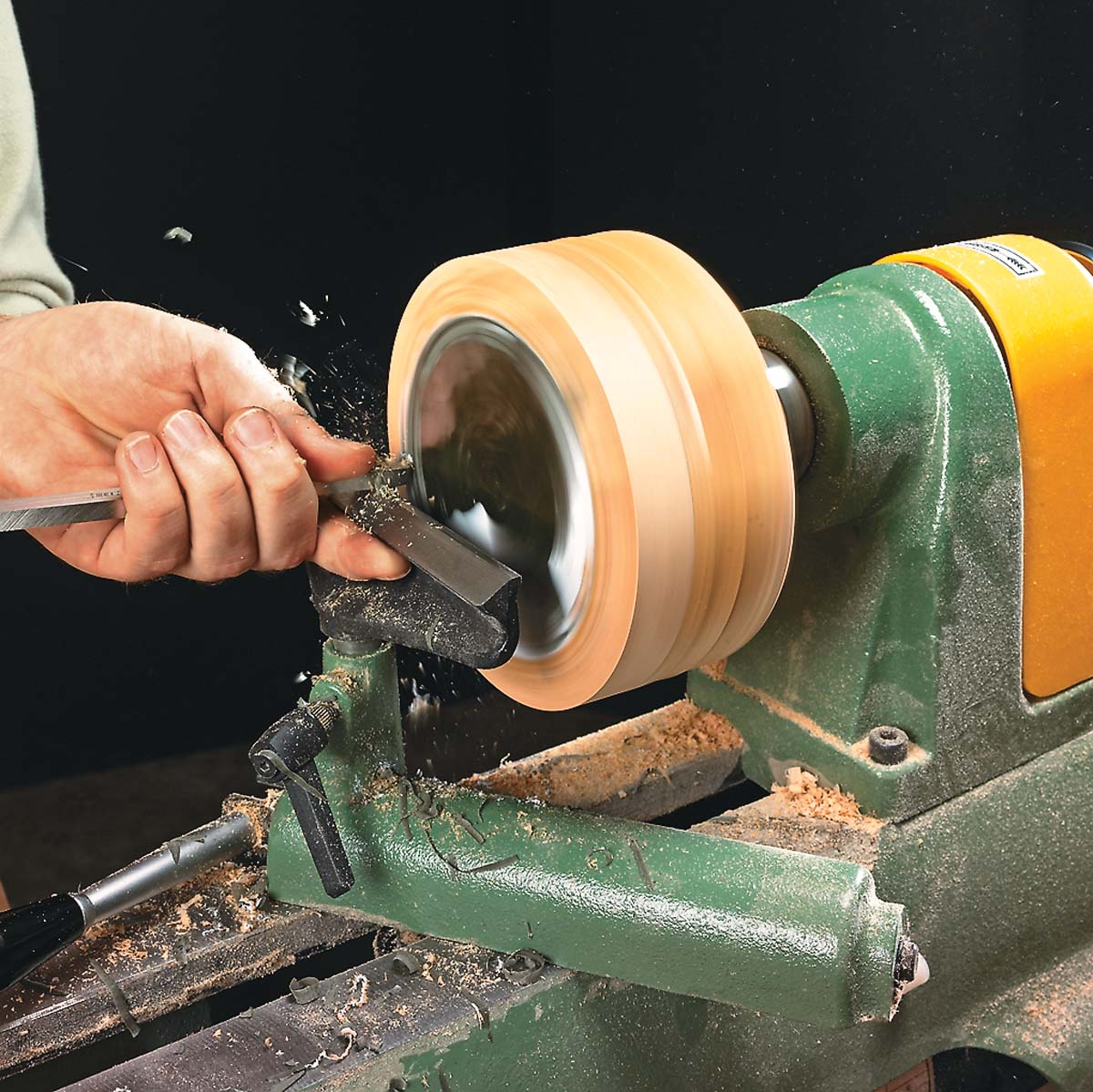 using square-end scrapper to smooth out reside of paper and epoxy, of turned gift box on lathe with round-nose scrapper
