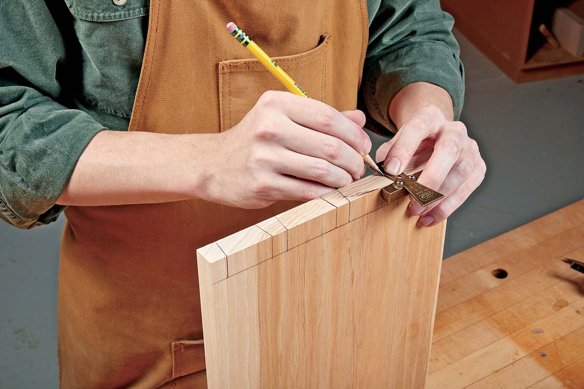 using dovetails guide and pencil to mark edge for dovetails