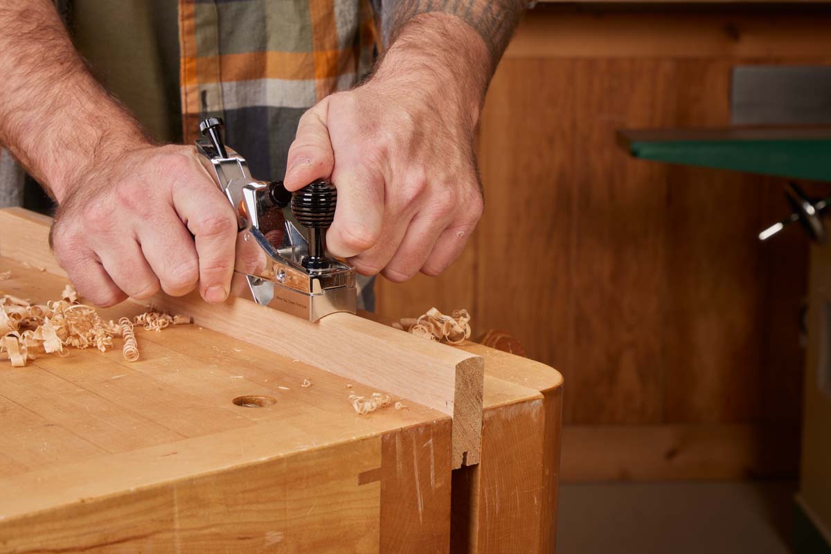 combination plane shaving wood piece