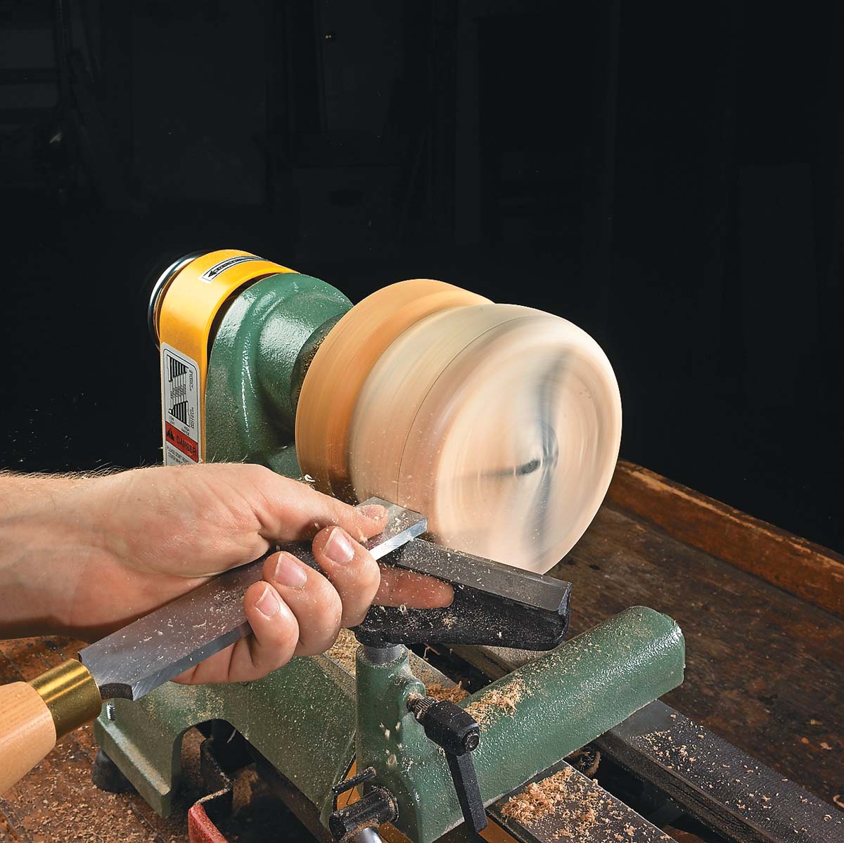 using square end scrapper to smooth side of box