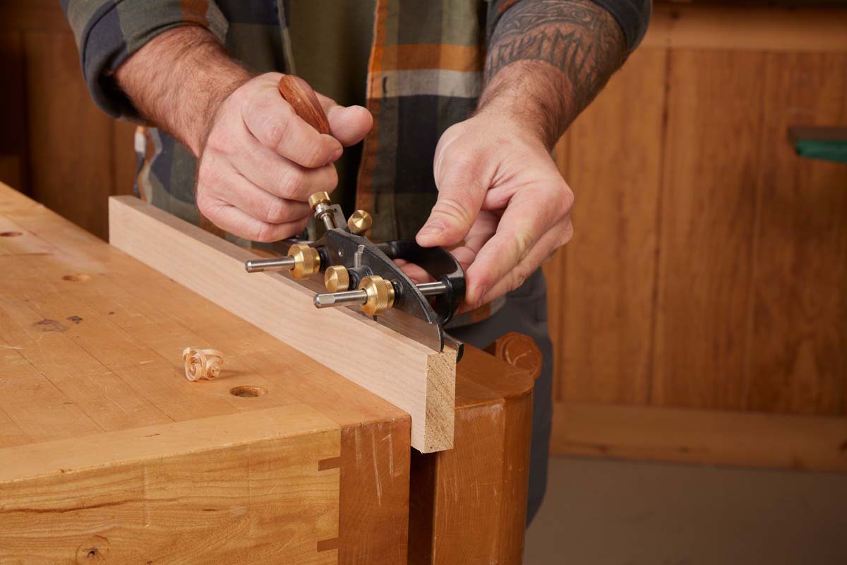 plow (plough) plane cutting along workpiece