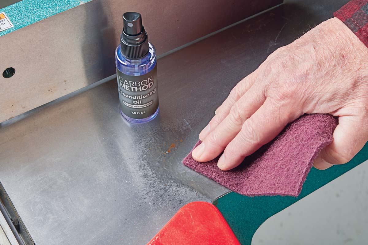 wiping away rust spot with abrasive pad and reconditioning oil