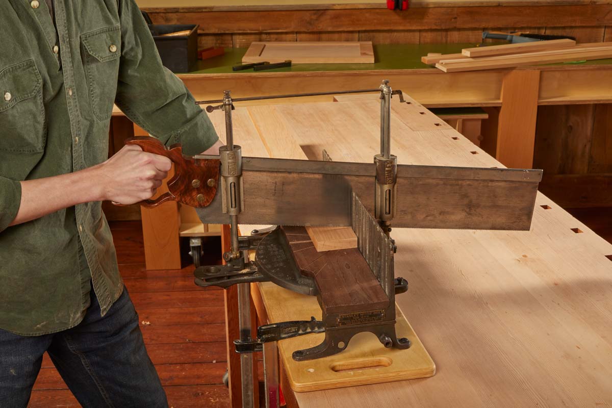 The two cylinders ride down with the back of the saw blade