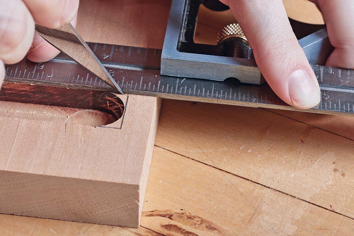 scoring wood with marking knife and using ruler