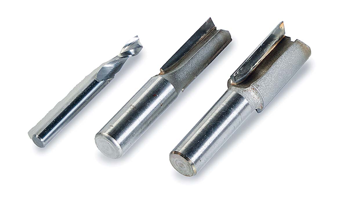 3 silver straight bits, a 1/4 spiral upcut bit, 1/2 straight bit, 3/4 straight bit