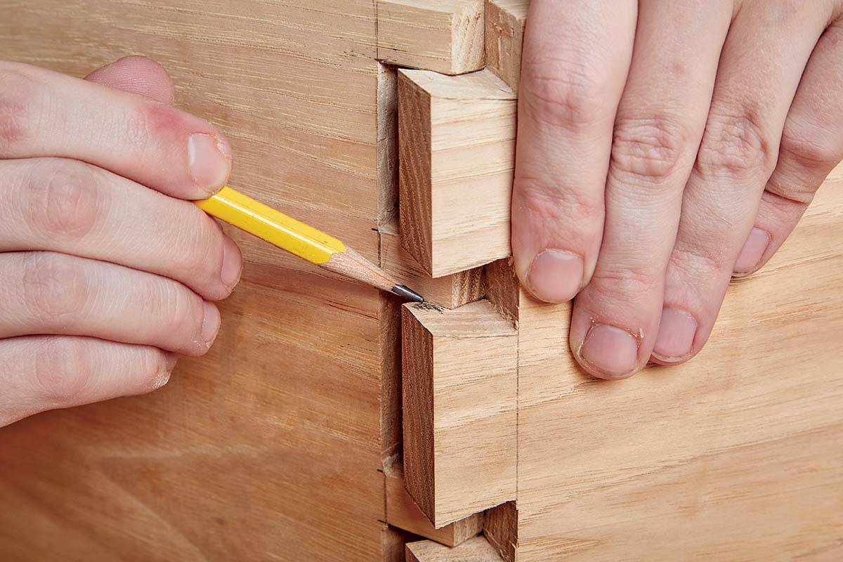 dry fitting dovetails and using pencil to mark uneven edges