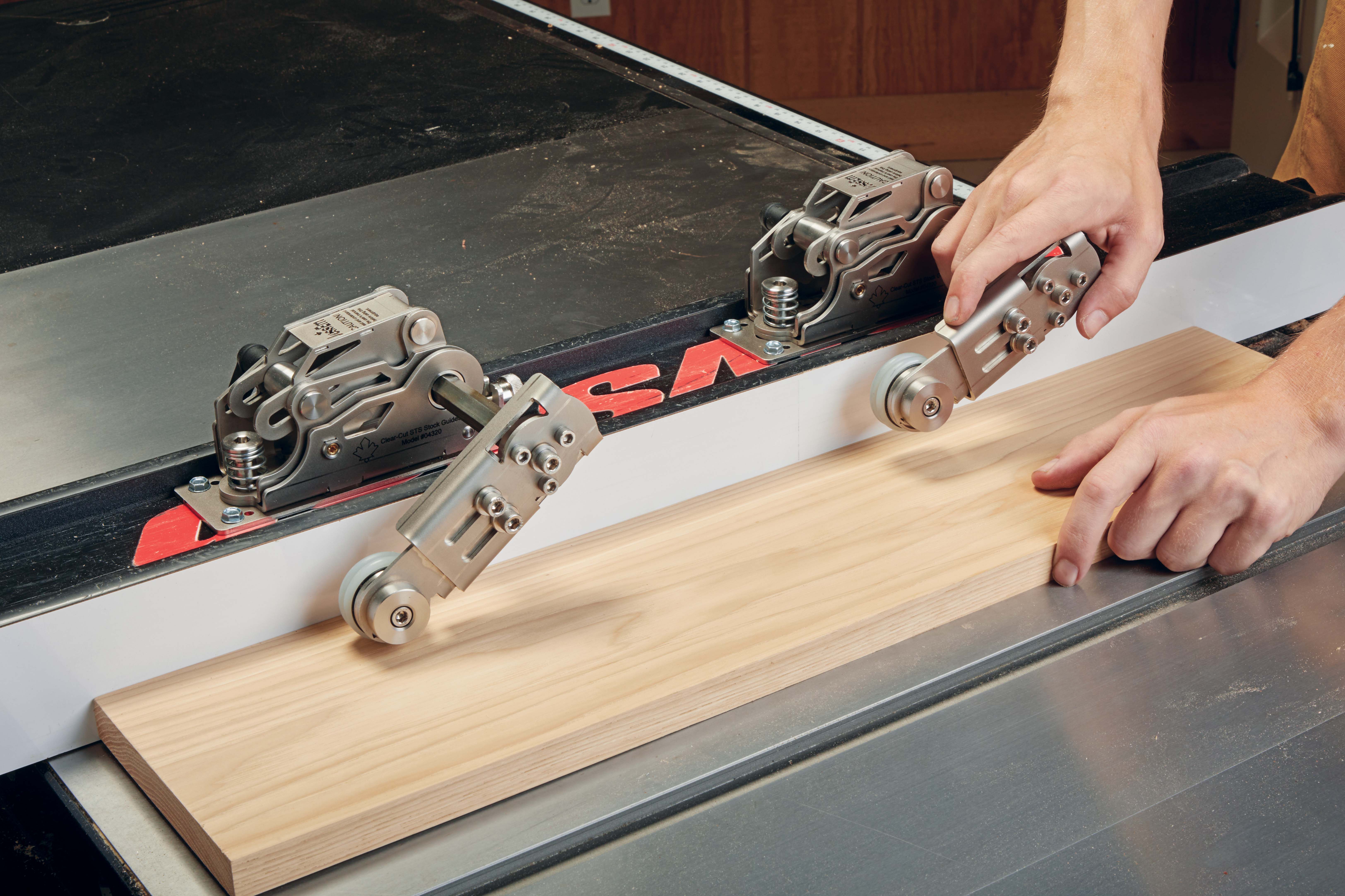 STS Stock Guide arms adjusting to stock thickness and the STS Stock Guide lever being used to lock in