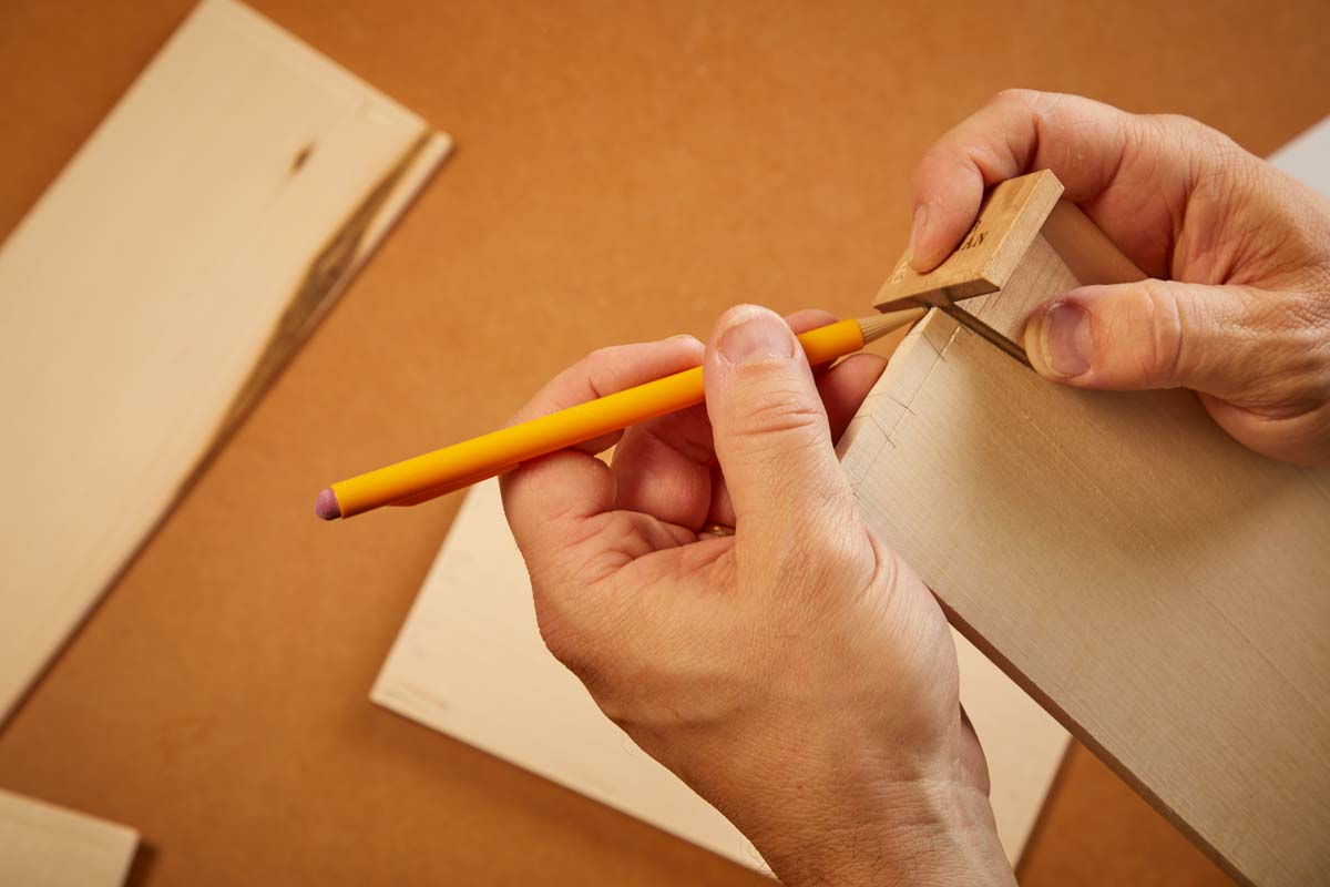 using dovetail marker to draw lines for cutting the dovetails