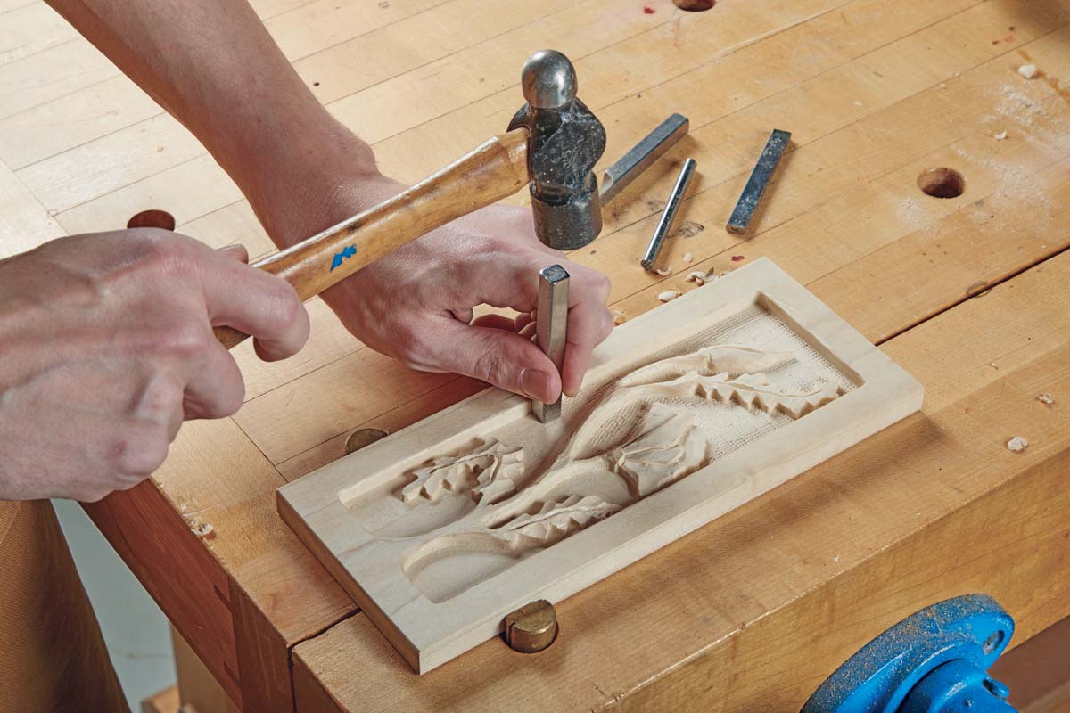 uisng stamping tool on background of relief carivng