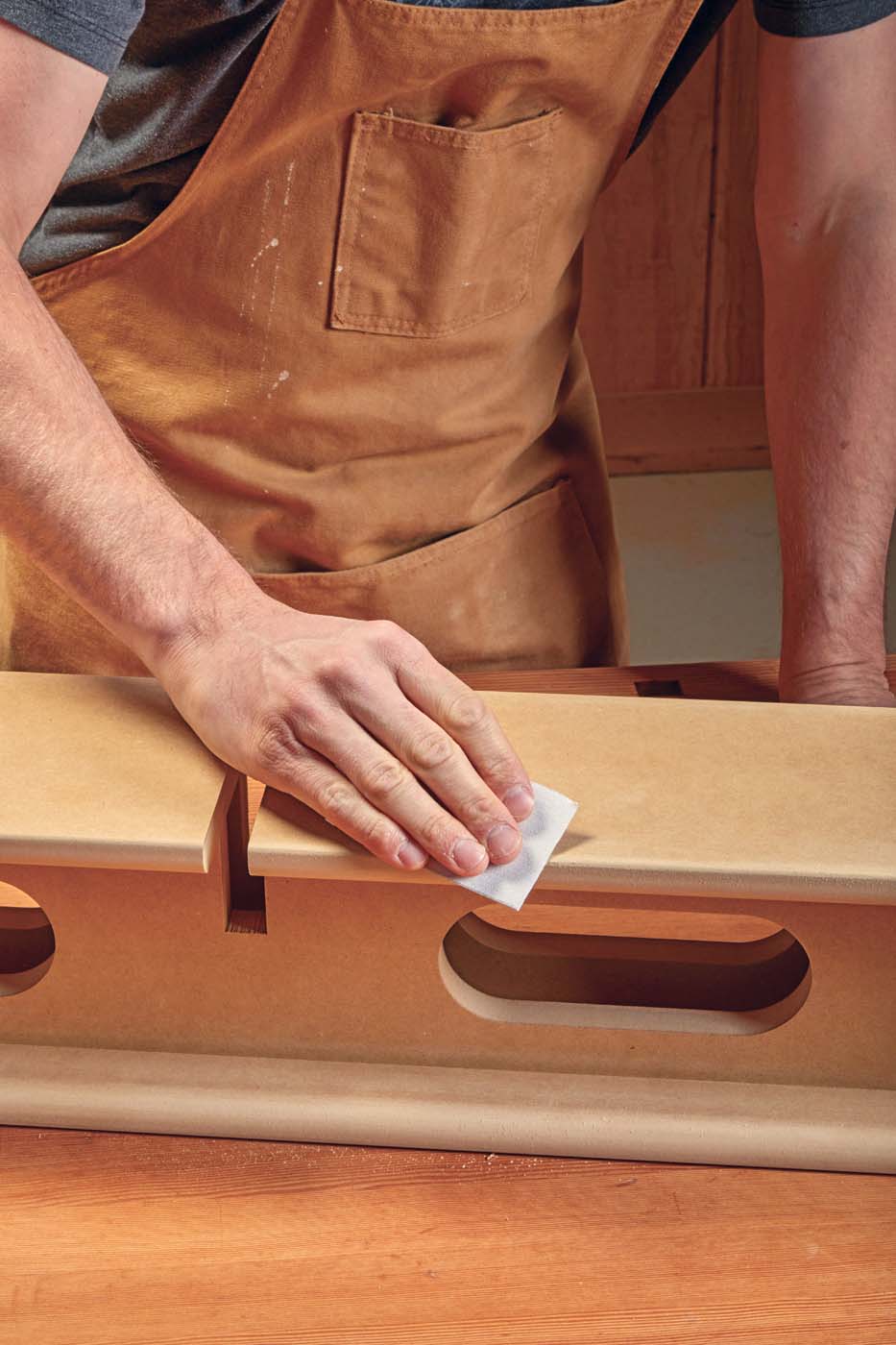 Sanding rough edges with grit sander until smooth