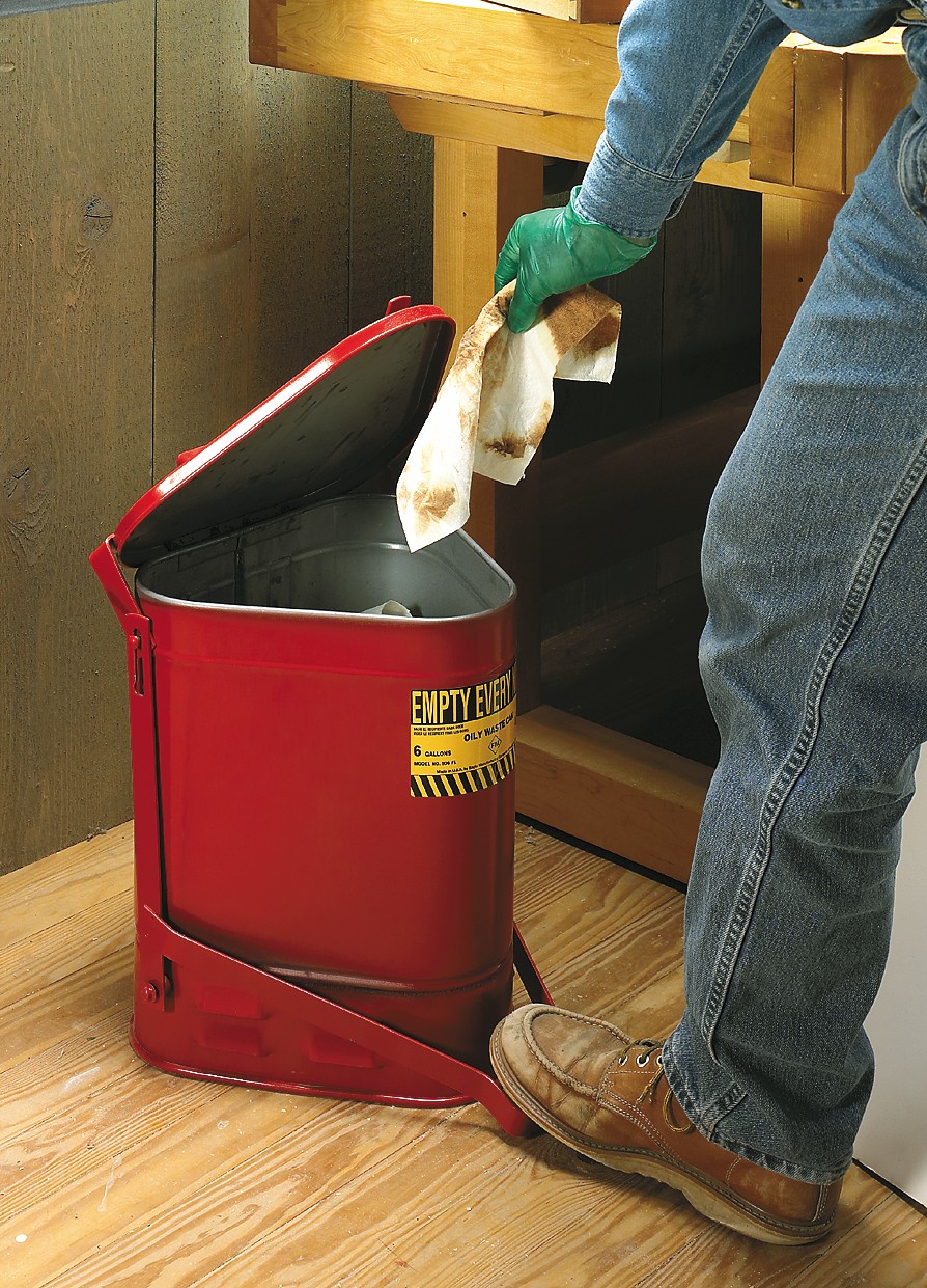 image shows open red trashcan and rag being thrown away