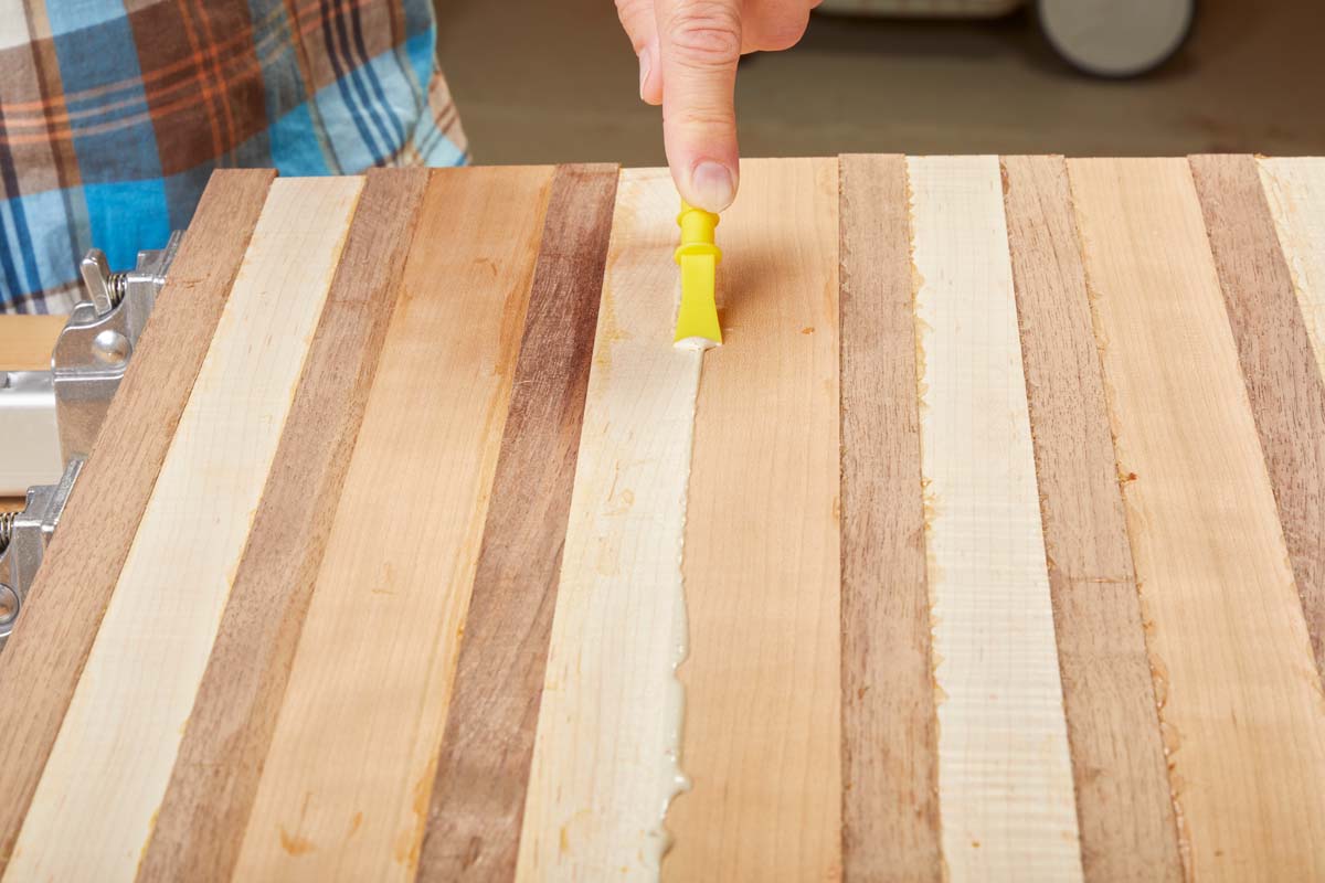 paddle end of the Titebrush scraping away glue