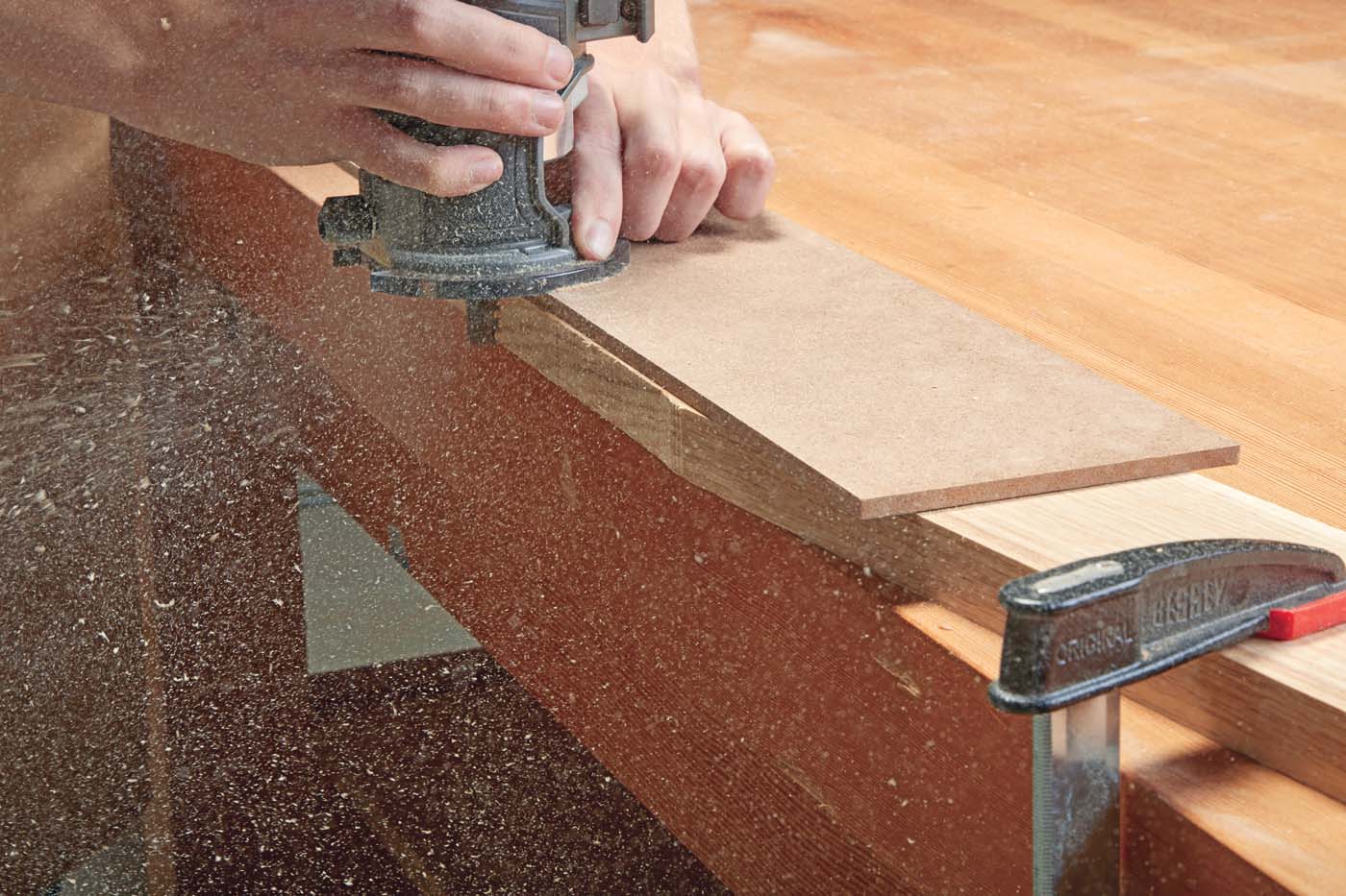 *Milwaukee’s* compact router in action on piece of wood