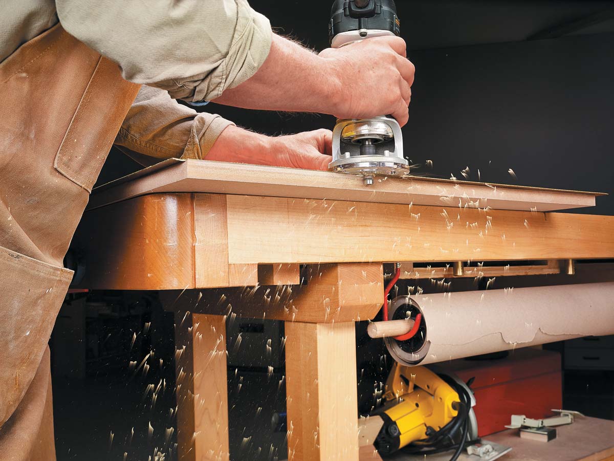 using palm router to trim the applied yellow laminate