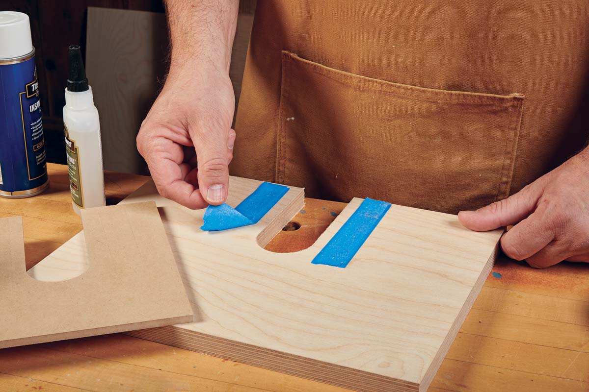 peeling blue masking tape off workpiece