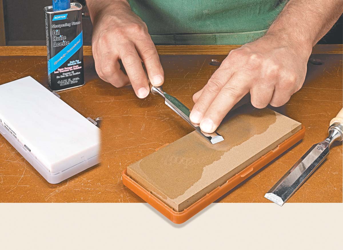 sharpening chisel on oil stone