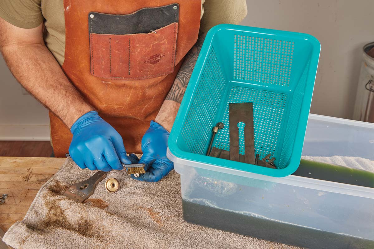 using brass brush to scrub parts of plane