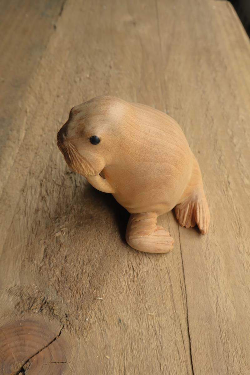 sanded smooth walrus carving with black eyes made from trimmed horn
