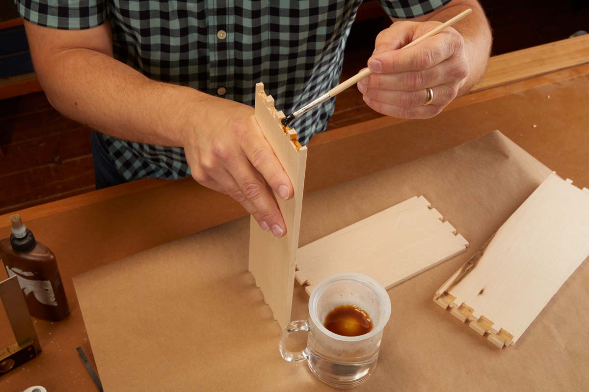 applying glue between dovetails with small brush