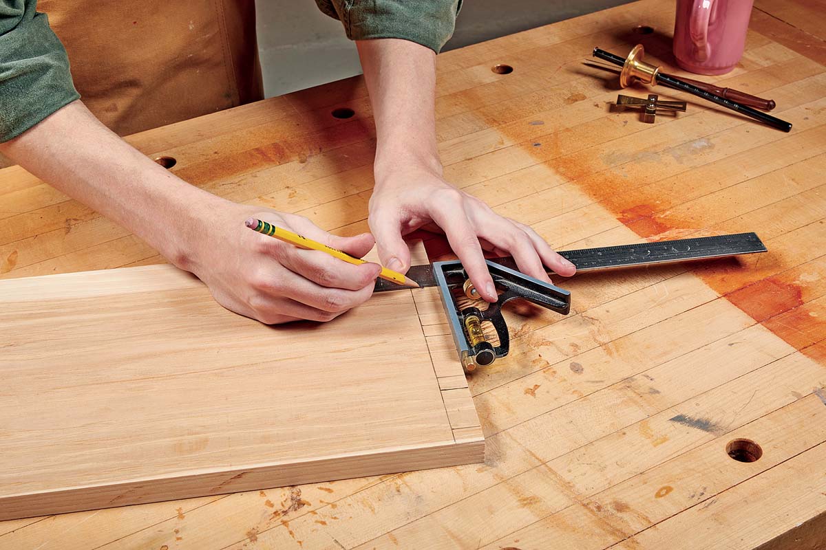using pencil and square to set baseline for dovetails