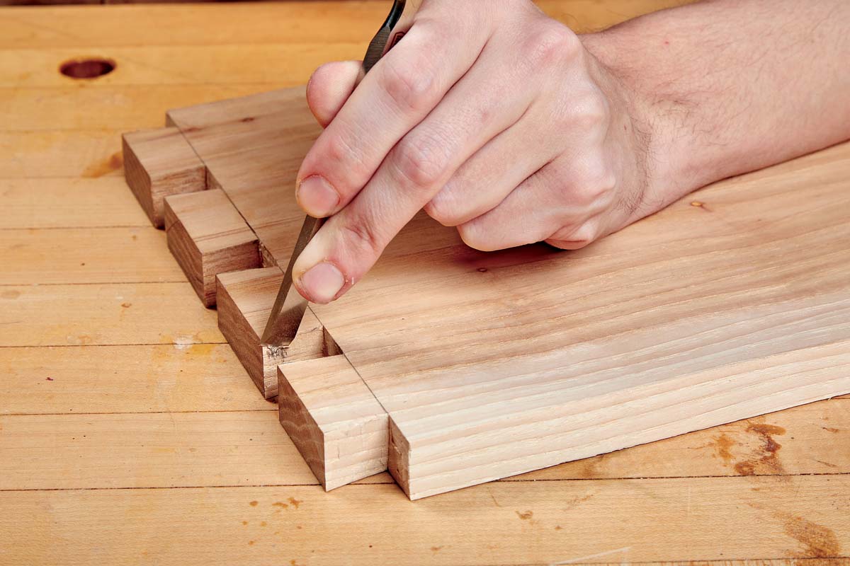 using chisel to pare away any extra bits on dovetails