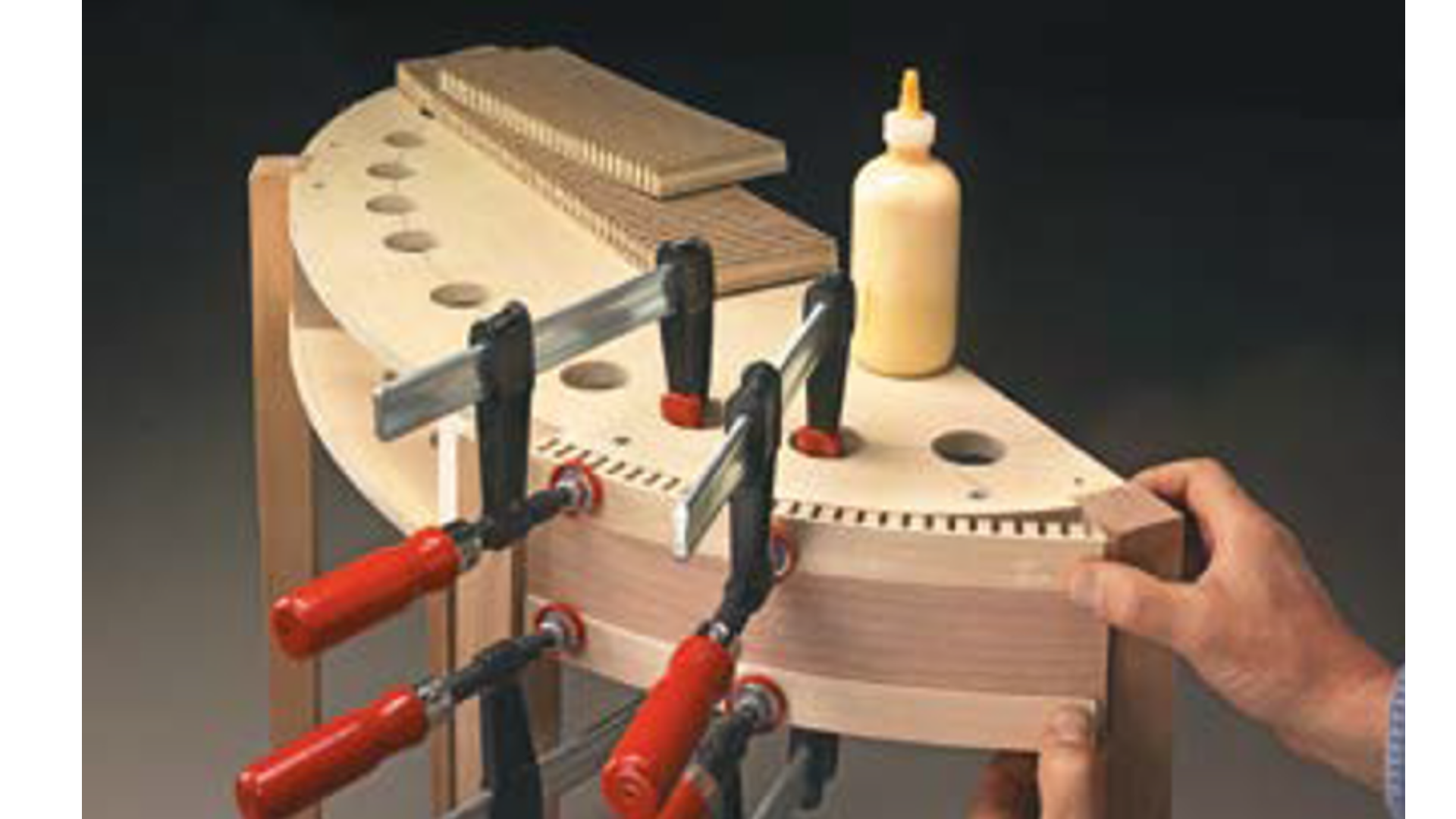half circle wood end table with kerfed board clamped together with a glued on backing