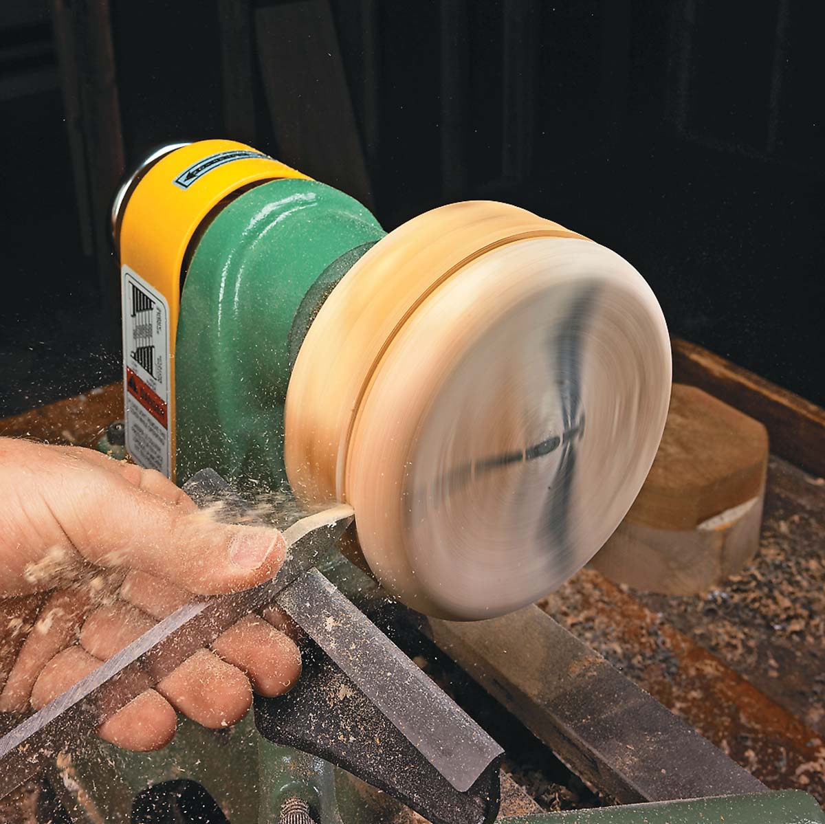 using parting tool to cut a rabbet along the bottom edge of the lid