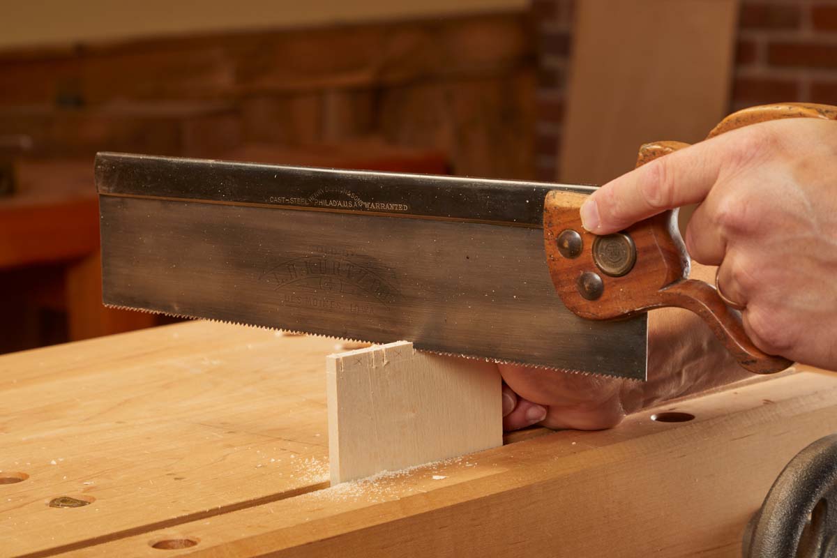 sawing vertically up and down with hand saw