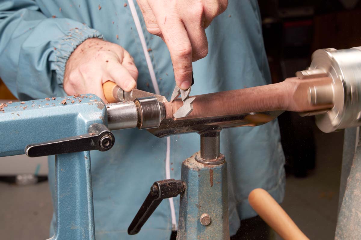 shaping marking knife on laithe figure 1, shows how to Use calipers to measure the brass tube, and transfer that to the blank