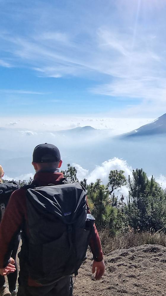 Trekkers climbing Acatenango above the clouds, Guatemala