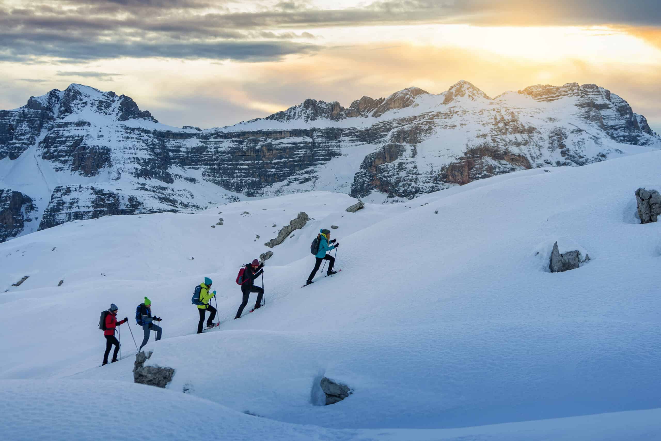 Row of hikers snowshoeing up a trail in the Dolomites, Italy. Photo: Host/Wild in the Dolomiti