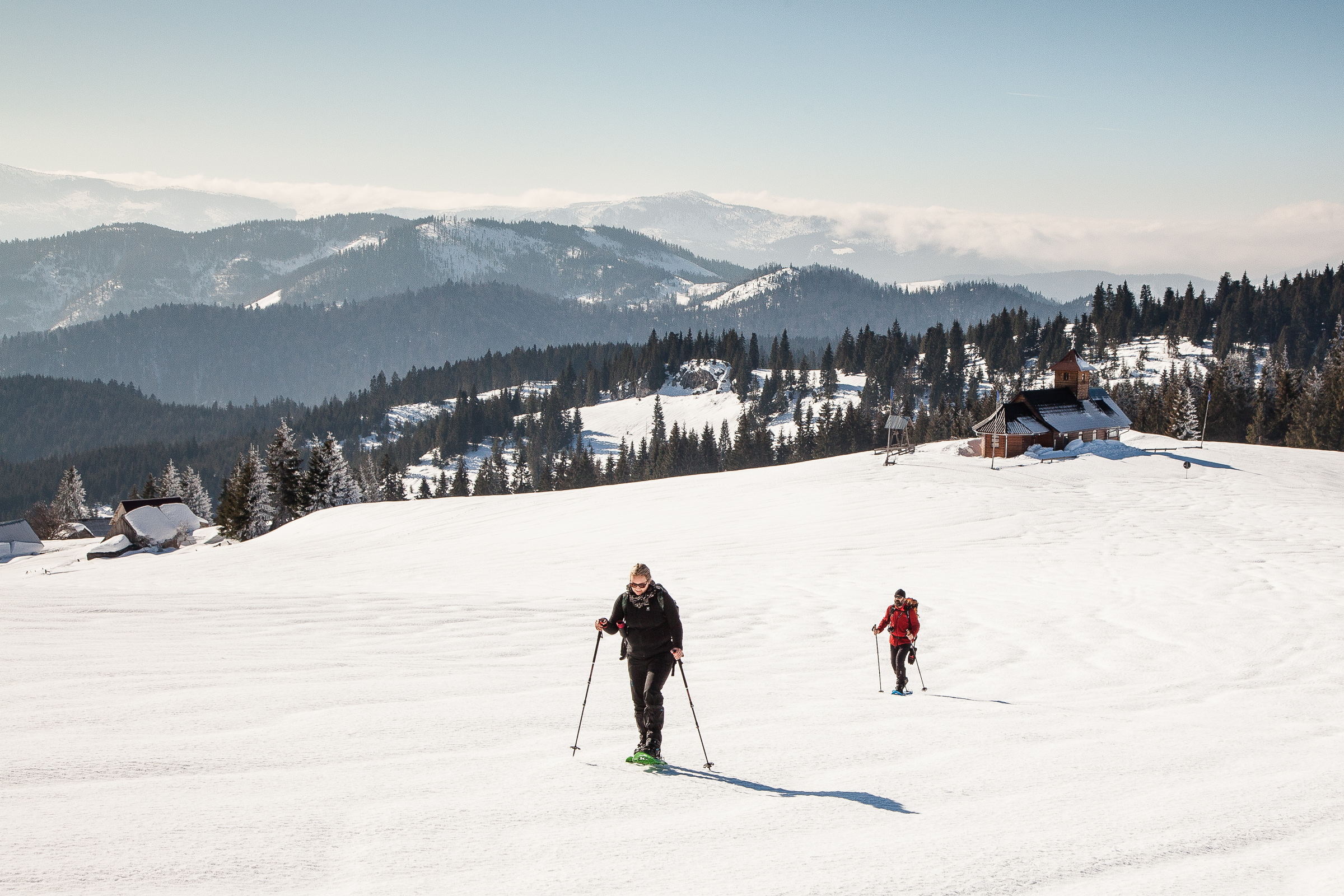2 People Winter Snowshoeing with a view in the Apuseni Mountains, Romania