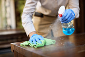 Close up of waitresses cleaning tables with sanitizer