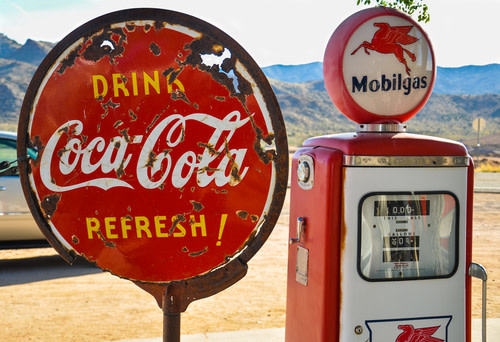 A rusty Coca Cola sign. 