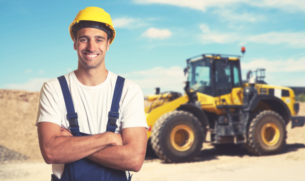Bulldozer with construction worker on construction site