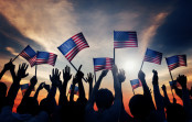 Group of people waving American Flags