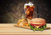Tasty fresh burger, fries and coke on wooden table