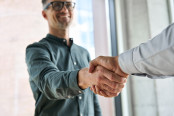 Advisor shaking hands with a happy client