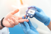 Doctor checking blood sugar with glucometer
