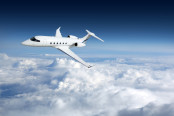 Business jet flying high above the clouds