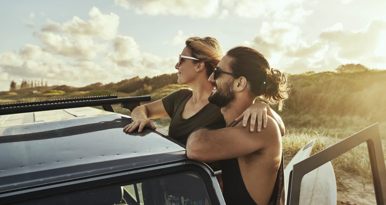Couple looking out at sea from beach