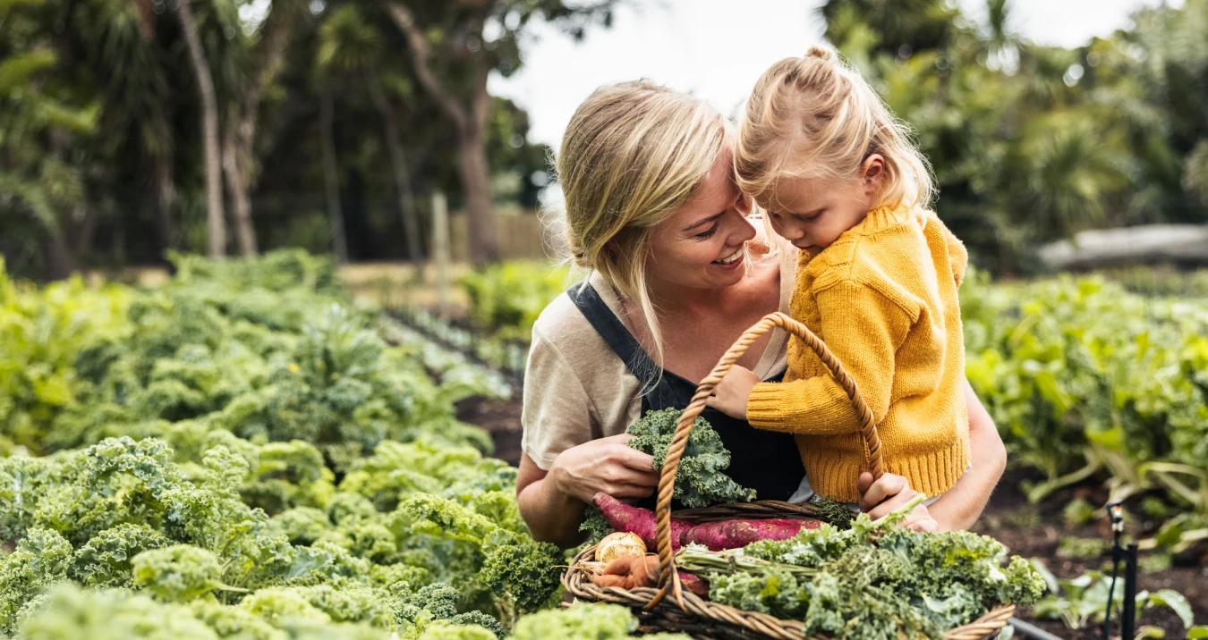 Mum and daughter picking vegetables