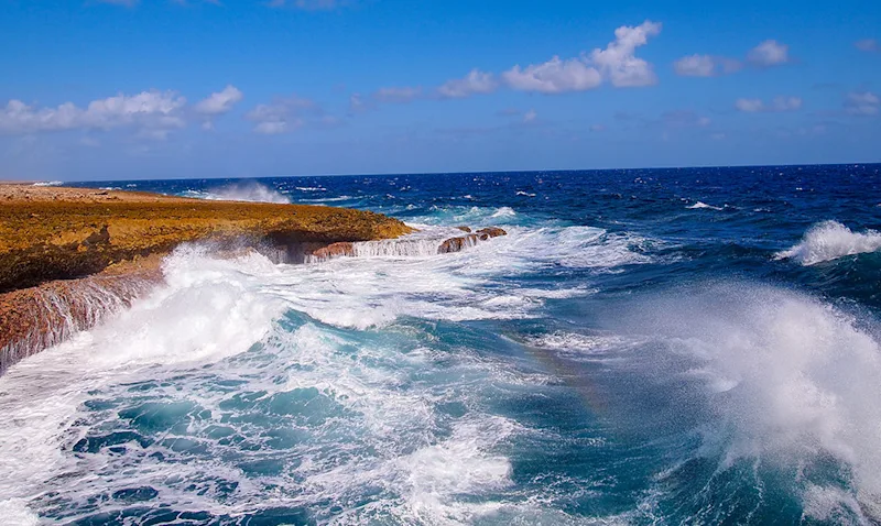 Waves crashing into the cliffs