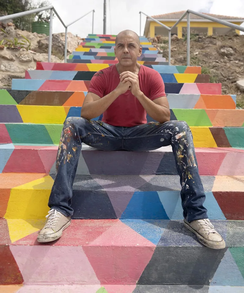 Garrick sitting on colorful steps.