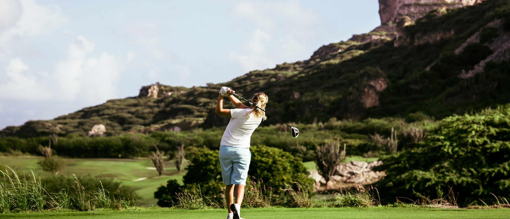 A woman playing golf.