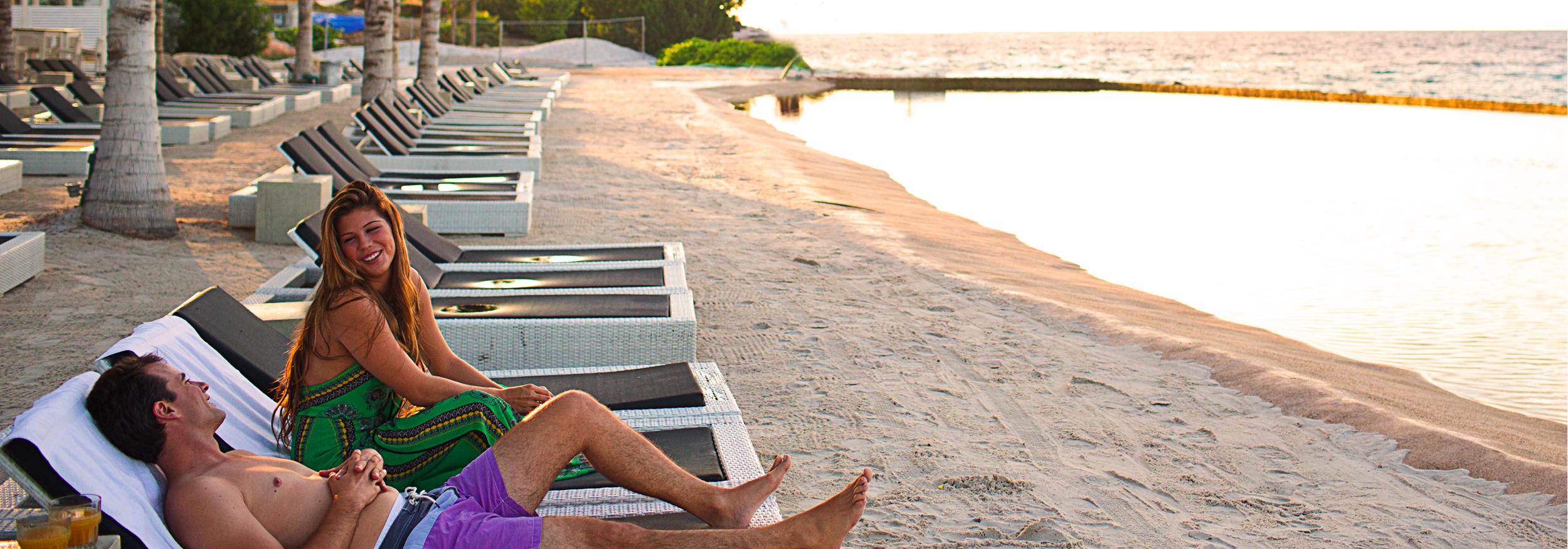A couple lounging on the beach. 